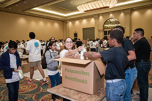 Volunteers packaging the Clean the World kits