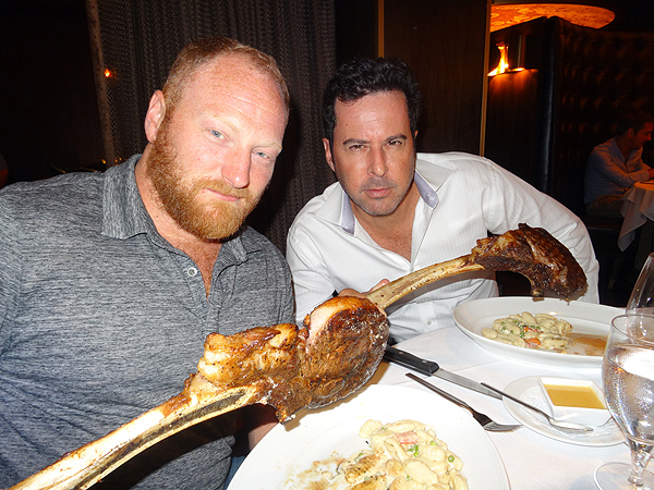 Actors Jonathan Silverman and Mac Brandt show off their huge Tomahawk steak at Andiamo Steak House in Las Vegas
