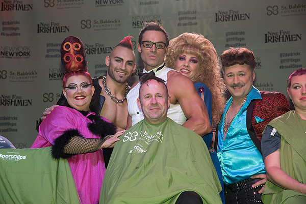 Cast members of Zumanity shave the head of their company manager