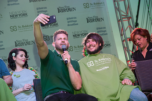 Host of Celebrity Page on OK TV Jaymes Vaughn poses with a shavee during eighth annual St. Baldricks Day head shaving event at New York New York Hotel Casino